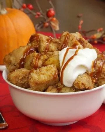 Just as good as warm pumpkin pie, this crock pot pumpkin bread pudding recipe is healthy enough for a fall breakfast, but it's enough of a treat, that it makes a wonderful dessert too! | www.CuriousCuisiniere.com
