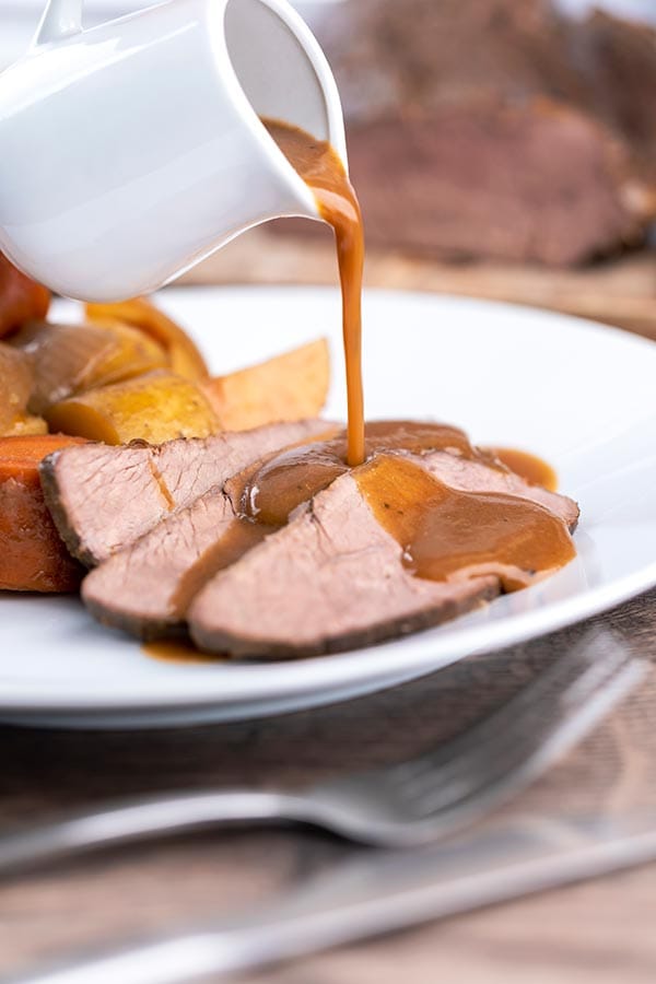Sliced, tender beer braised venison roast