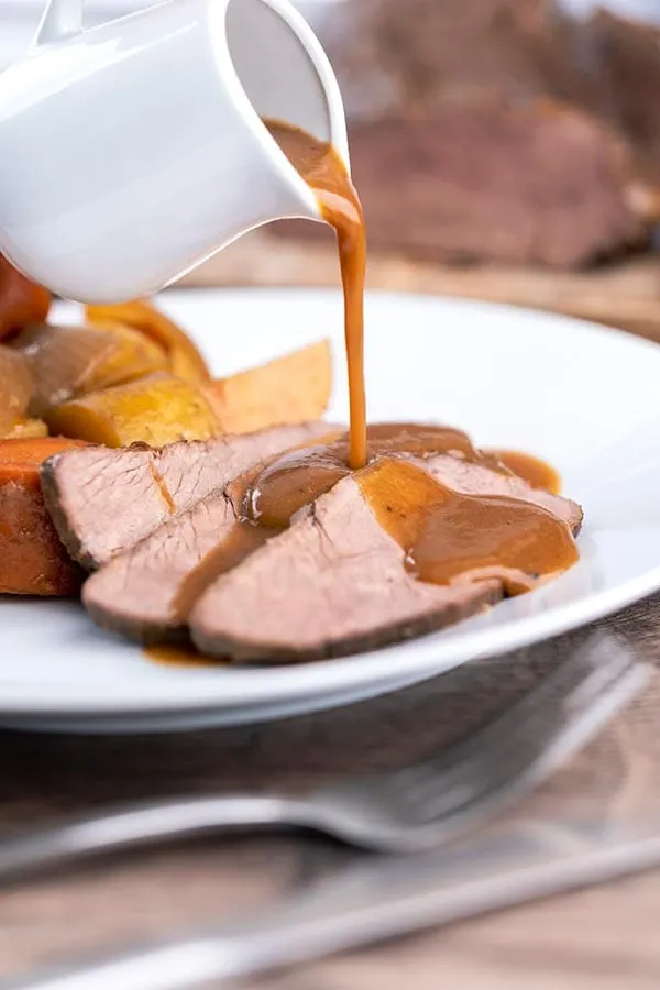 Sliced, tender beer braised venison roast