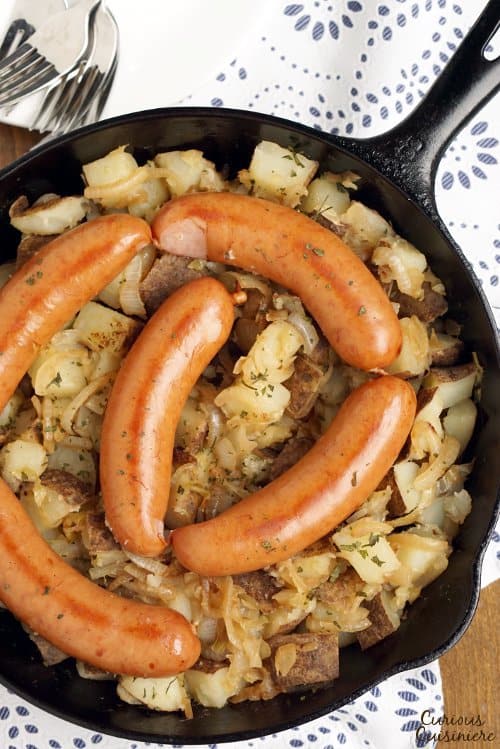 Polish Sausage and Sauerkraut are a match made in heaven. Add some potatoes and onions, and you have yourself a full meal! | www.CuriousCuisiniere.com 