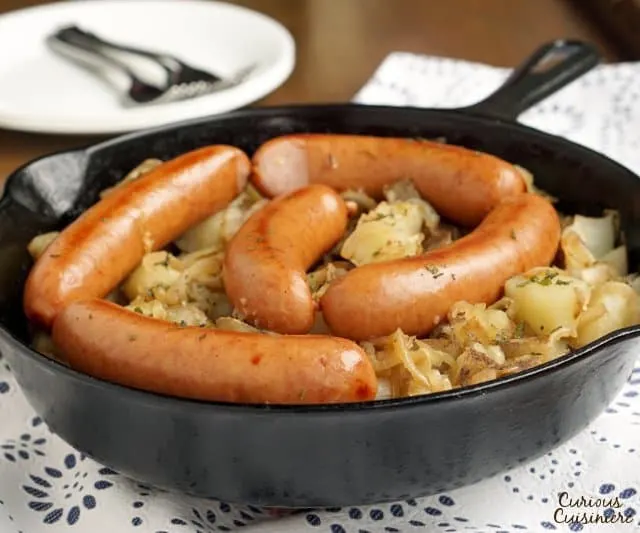 Polish Sausage and Sauerkraut are a match made in heaven. Add some potatoes and onions, and you have yourself a full meal! | www.CuriousCuisiniere.com 