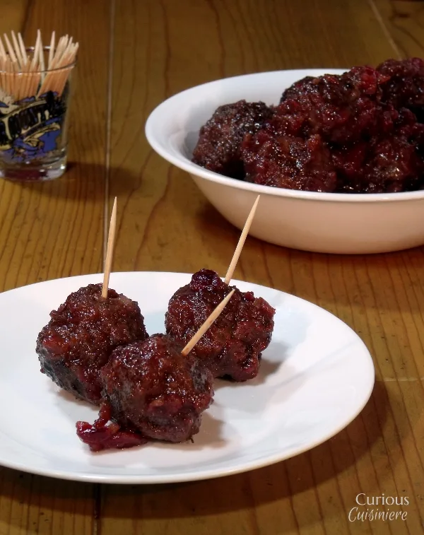 Sweet and slightly tangy cranberries make the perfect glaze for these Venison Meatballs that pack just a slight cayenne kick. - Cranberry Glazed Meatballs - Curious Cuisiniere
