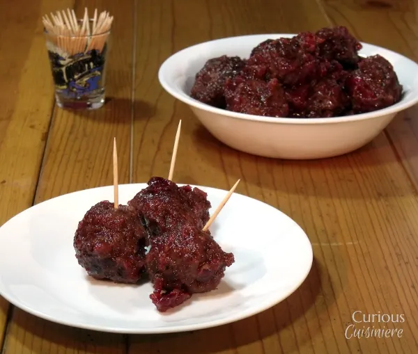 Sweet and slightly tangy cranberries make the perfect glaze for these Venison Meatballs that pack just a slight cayenne kick. - Cranberry Glazed Meatballs - Curious Cuisiniere