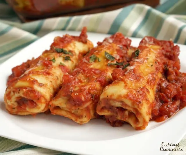 Spinach and Ricotta Cannelloni is a classic Italian stuffed pasta dish. We'll show you how to make your own easy cannelloni pasta and give you an even easier "cheat" way to make the dish! | www.CuriousCuisiniere.com 