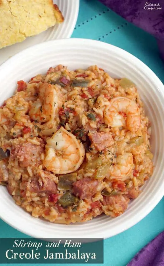 Shrimp and Ham Creole Jambalaya is a hearty and flavorful dish that is perfect for Mardi Gras or any time you want a taste of New Orleans! | www.CuriousCuisiniere.com | Recipe from @CCuisiniere