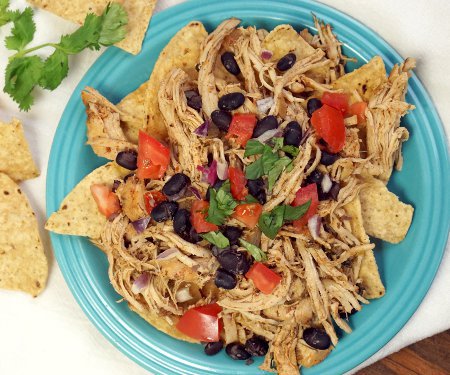 Smoky and slightly spicy, this Crock Pot Southwest Pulled Chicken is as flavorful as it is versatile and easy to make. | www.CuriousCuisiniere.com