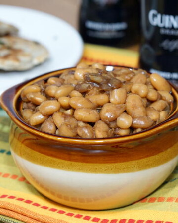 Not your classic sweet and sticky BBQ Baked Beans, these Guinness Baked Beans boast a mild and malty sweetness with a deep and robust flavor. | www.CuriousCuisiniere.com
