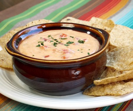 This Smoky Chili Con Queso Sauce makes for some mean cheese nachos, or if you prefer, just grab a bowl and start dipping anything you have on hand. Chips, bread, veggies: they're all better with a little cheese! | www.CuriousCuisiniere.com
