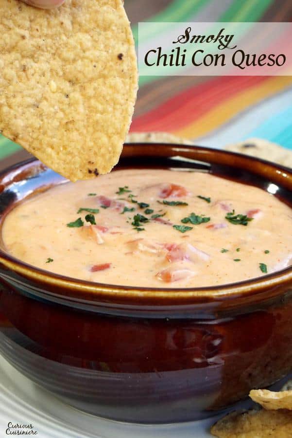 This Smoky Chili Con Queso Sauce makes for some mean cheese nachos, or if you prefer, just grab a bowl and start dipping anything you have on hand. Chips, bread, veggies: they're all better with a little cheese! | www.CuriousCuisiniere.com