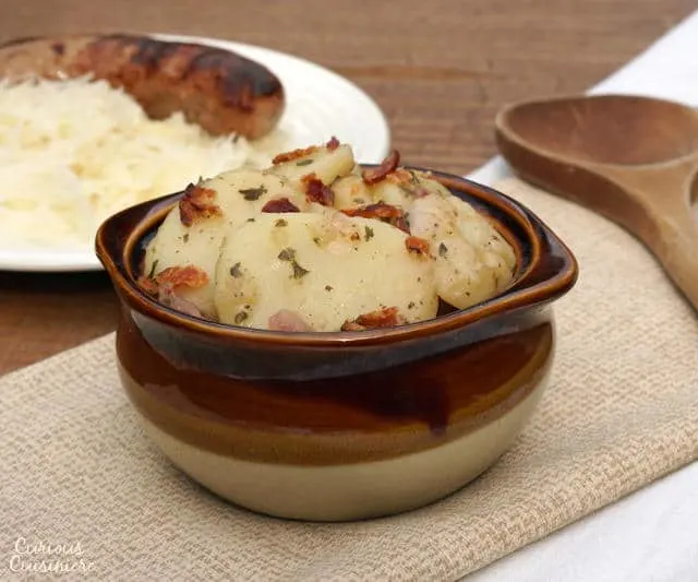 Tangy and slightly sweet, this Bavarian Potato Salad brings bacon and a warm vinegar dressing together for one tasty side dish! | www.CuriousCuisiniere.com 