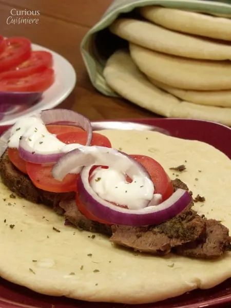 Venison steak (or beef) is sliced thin, marinated, and piled on flatbread to create these Venison Gyros, a easy twist on the classic Greek street food. - Venison Steak Gyros from Curious Cuisiniere