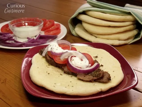 Venison steak (or beef) is sliced thin, marinated, and piled on flatbread to create these Venison Gyros, a easy twist on the classic Greek street food. - Venison Steak Gyros from Curious Cuisiniere