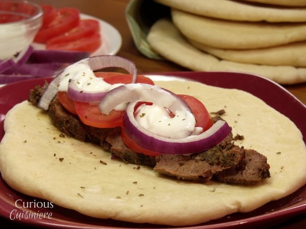 Venison steak (or beef) is sliced thin, marinated, and piled on flatbread to create these Venison Gyros, a easy twist on the classic Greek street food. - Venison Steak Gyros from Curious Cuisiniere