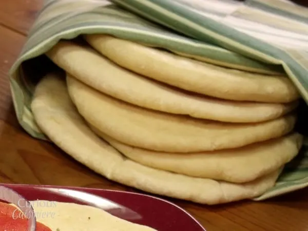 A soft and chewy, this easy to make Greek Flatbread is the perfect base for a gyro and is great for dipping in creamy hummus. | Curious Cuisiniere
