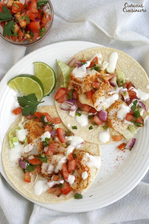 Fish Tacos are a classic Mexican dish that has made their way to Southern California. This version uses grilled fish and a lime salsa for a bright combo! | www.CuriousCuisiniere.com