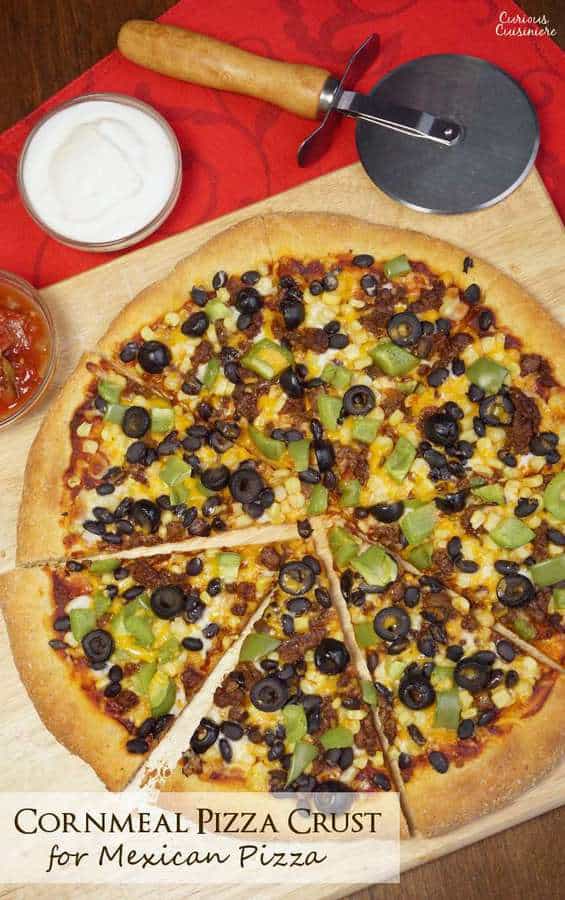 This Cornmeal Pizza Crust recipe is quick and easy to make. Load up your Mexican Pizza with your favorite Mexican inspired toppings for an easy weeknight meal! | www.CuriousCuisiniere.com
