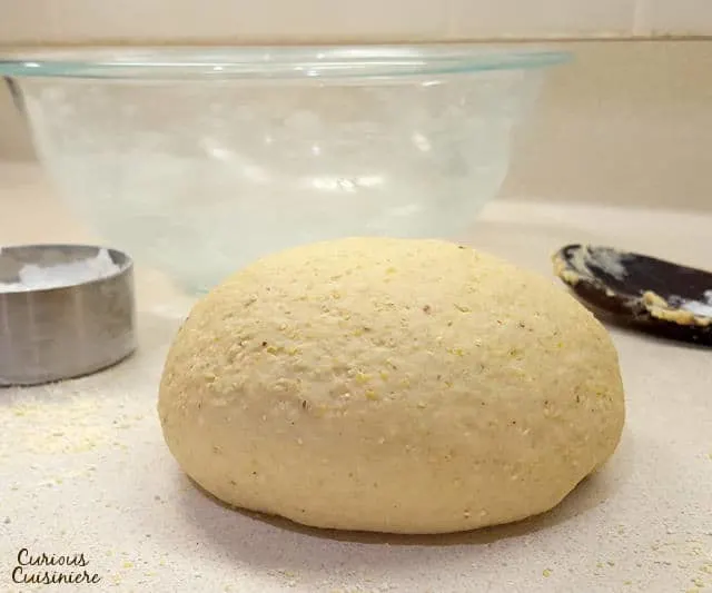 This Cornmeal Pizza Crust recipe is quick and easy to make. Load up your Mexican Pizza with your favorite Mexican inspired toppings for an easy weeknight meal! | www.CuriousCuisiniere.com