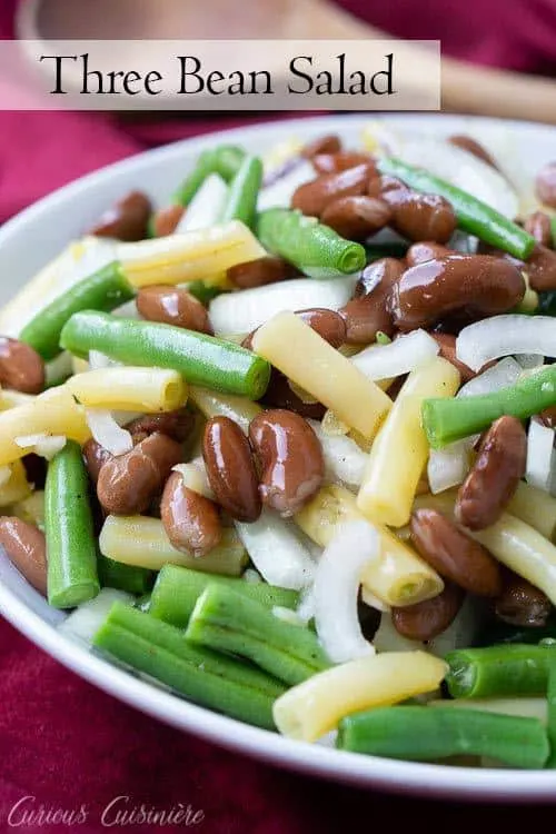 This Southern Green Bean Salad, aka Three Bean Salad, combines green beans, kidney beans, and wax beans into a tangy side dish perfect for any meal. | www.CuriousCuisiniere.com
