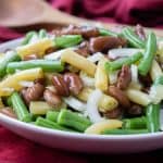 This Southern Green Bean Salad, aka Three Bean Salad, combines green beans, kidney beans, and wax beans into a tangy side dish perfect for any meal. | www.CuriousCuisiniere.com