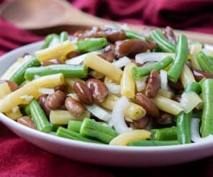 This Southern Green Bean Salad, aka Three Bean Salad, combines green beans, kidney beans, and wax beans into a tangy side dish perfect for any meal. | www.CuriousCuisiniere.com