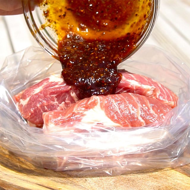 Country style rib marinade pouring over raw pork