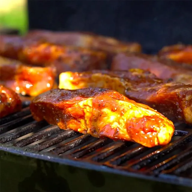 Grilling country style ribs with marinade, side shot