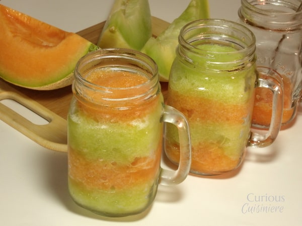 This layered Melon Granita combines brightly colored layers of sweet honeydew granita and spiced cantaloupe granita make a sweet, guilt free summer treat. | Curious Cuisiniere