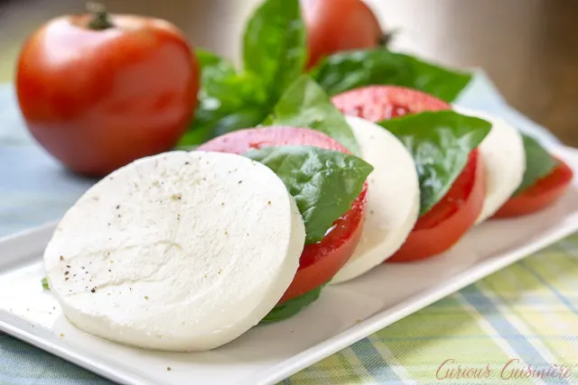 Insalata Caprese (or Caprese Salad) with juicy tomatoes, fresh basil, and soft mozzarella cheese. | www.CuriousCuisiniere.com 