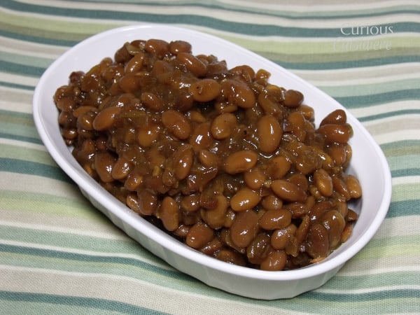 The crock pot makes it easy to make flavorful homemade BBQ Baked Beans. Get ready to come home to a house that smells like barbecue heaven! | Curious Cuisiniere