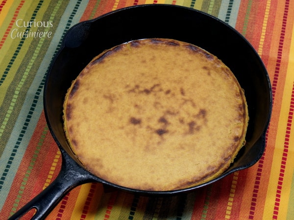 A street food specialty of southeastern French cuisine, socca is the perfect flatbread for munching as an afternoon snack. And it goes great with a glass of rosé wine! | Curious Cuisiniere