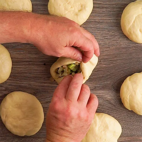 Making Bierocks (German Stuffed Rolls) wrapping up the filling