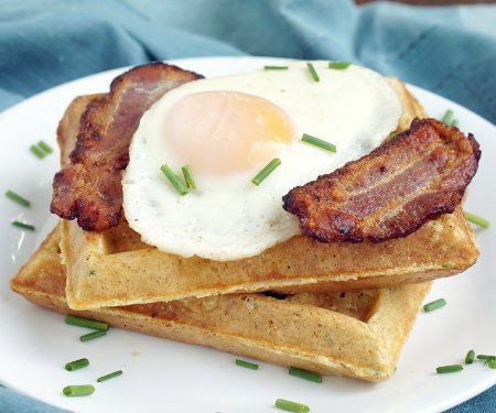 A stack of delicious, savory Cornmeal Waffles is the perfect breakfast or dinner, particularly with a fried egg and bacon! | www.CuriousCuisiniere.com