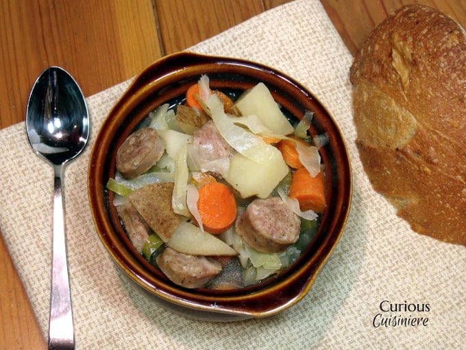 Bratwurst, potatoes, cabbage, and carrots mingle in this hearty Slow Cooker Oktoberfest Stew that gets an extra pump of flavor from a good dose of German beer. | CuriousCuisiniere.com Oktoberfest Stew from Curious Cuisiniere