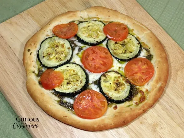 Garlic, oregano and a homemade pesto make this Roasted Zucchini Pizza a recipe that you do not want to miss! | Curious Cuisiniere