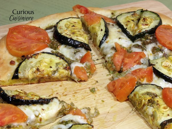 Garlic, oregano and a homemade pesto make this Roasted Zucchini Pizza a recipe that you do not want to miss! | Curious Cuisiniere