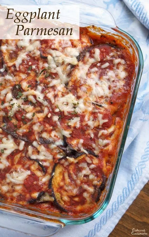Parmigiana di Melanzane, or Eggplant Parmesan, is a simple but elegant Italian recipe. Our version of this vegetarian dish is lighter than many and includes a Fresh Herb Tomato Sauce that is perfect for summer! | www.CuriousCuisiniere.com 