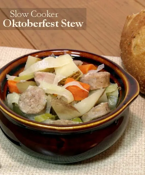 Bratwurst, potatoes, cabbage, and carrots mingle in this hearty Slow Cooker Oktoberfest Stew that gets an extra pump of flavor from a good dose of German beer. | CuriousCuisiniere.com