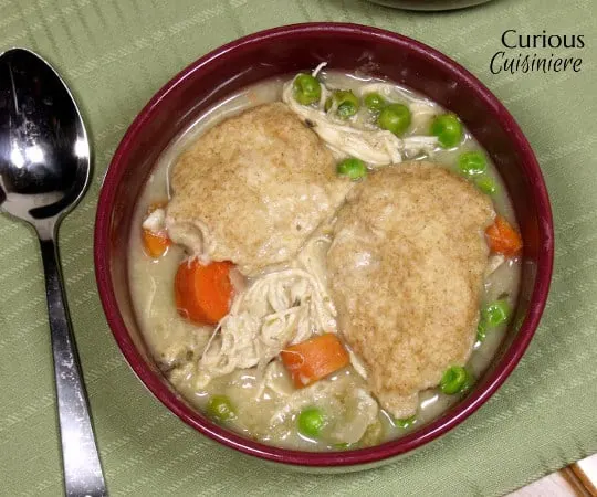 This Crock Pot Chicken and Dumplings recipe is a hearty and slightly creamy stew made completely from scratch. (No canned soups here!) | www.curiouscuisiniere.com