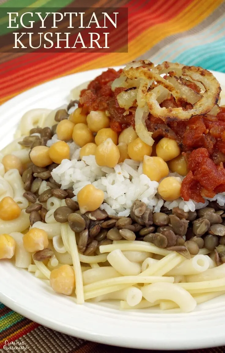 Often called the national dish of Egypt, Kushari is a hearty combination of flavors and textures all topped off with spicy tomato sauce and fried onions. | www.CuriousCuisiniere.com