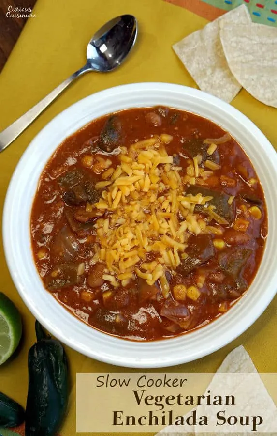 This slow cooker Vegetarian Enchilada Soup is packed full of flavorful peppers and hearty beans for a quick weeknight meal. | www.CuriousCuisiniere.com