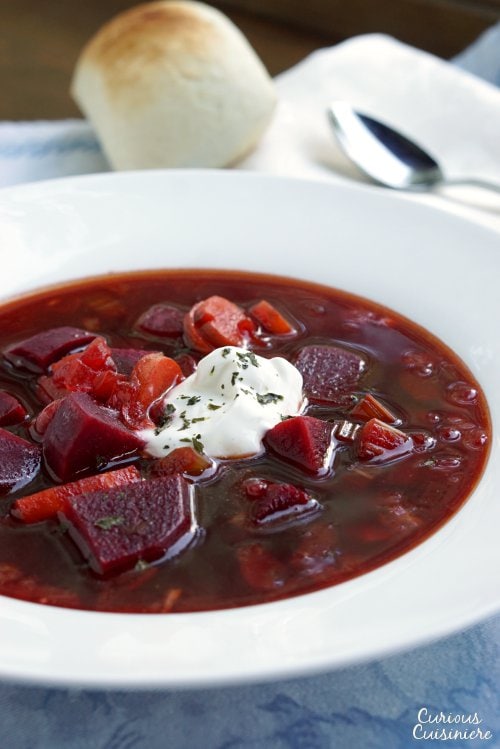 Our Polish Borscht recipe (Barszcz) creates a beet soup that is chock full of veggies and boasts a bright, sweet and sour flavor making it a perfect first course or warming meal. | www.CuriousCuisiniere.com