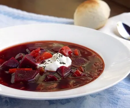 Our Polish Borscht recipe (Barszcz) creates a beet soup that is chock full of veggies and boasts a bright, sweet and sour flavor making it a perfect first course or warming meal. | www.CuriousCuisiniere.com