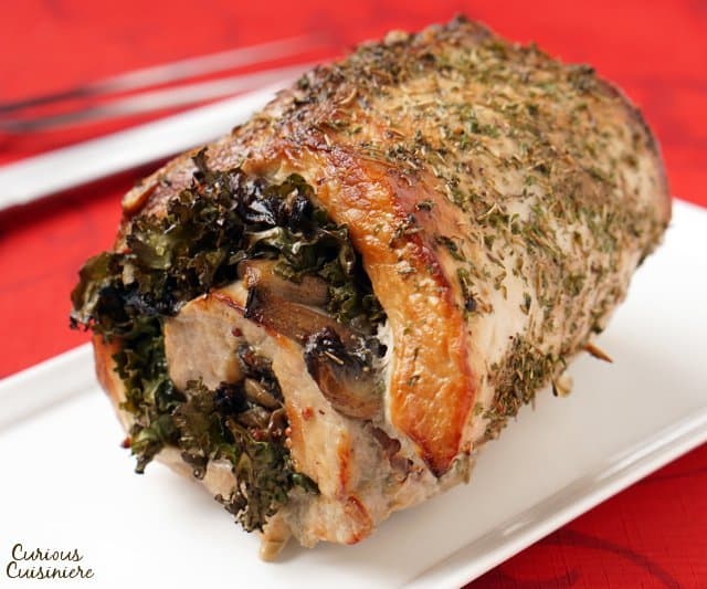 Mushrooms sauteed in wine and mustard pairs perfectly with sweet Swiss chard in this Rolled Pork Loin Roast. | www.CuriousCuisiniere.com