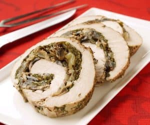 Mushrooms sauteed in wine and mustard pairs perfectly with sweet Swiss chard in this Rolled Pork Loin Roast. | www.CuriousCuisiniere.com