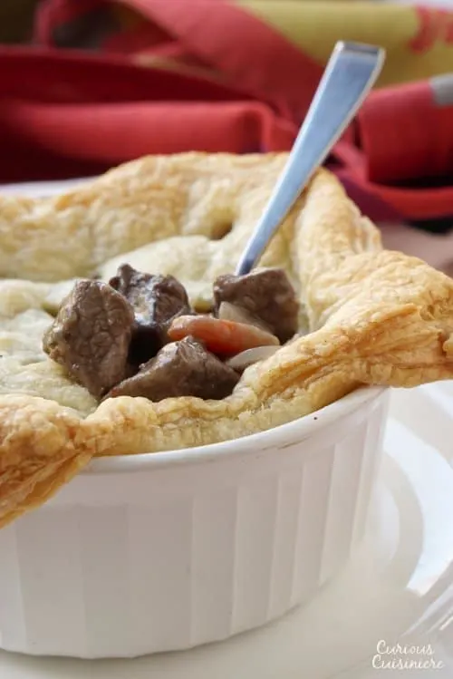 These individual Beef Burgundy Pot Pies evoke all the slow-cooked flavor of a traditional French Boeuf Bourguignon, with an added flaky pastry top! | www.CuriousCuisiniere.com