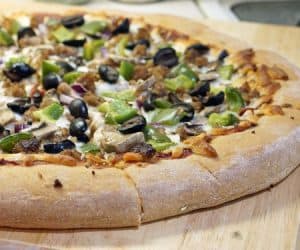 Making pizza is incredibly simple when you break out your bread machine! This Bread Machine Whole Wheat Pizza Dough recipe is so easy, you'll want homemade pizza every night!  | www.CuriousCuisiniere.com