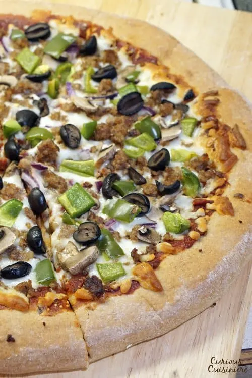 Making pizza is incredibly simple when you break out your bread machine! This Bread Machine Whole Wheat Pizza Dough recipe is so easy, you'll want homemade pizza every night!  | www.CuriousCuisiniere.com