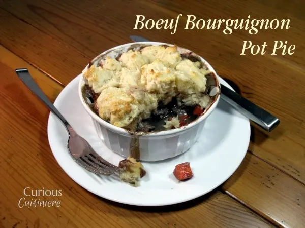 These individual Beef Burgundy Pot Pies evoke all the slow-cooked flavor of a traditional French Boeuf Bourguignon, with an added biscuit topping! | Curious Cuisiniere