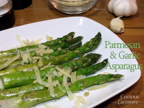 Parmesan cheese adds a richness to these garlic and lemon flavored asparagus spears. They make the perfect spring and Easter side dish. | Curious Cuisiniere