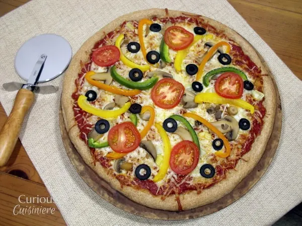 This Bread Machine Whole Wheat Pizza Dough recipe is so simple, you'll want homemade pizza every night! | Curious Cuisiniere